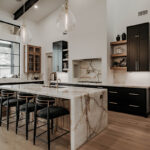 Painted and stained large open kitchen with beams on ceiling