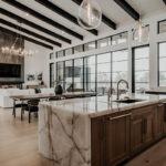 Painted and stained large open kitchen with beams on ceiling