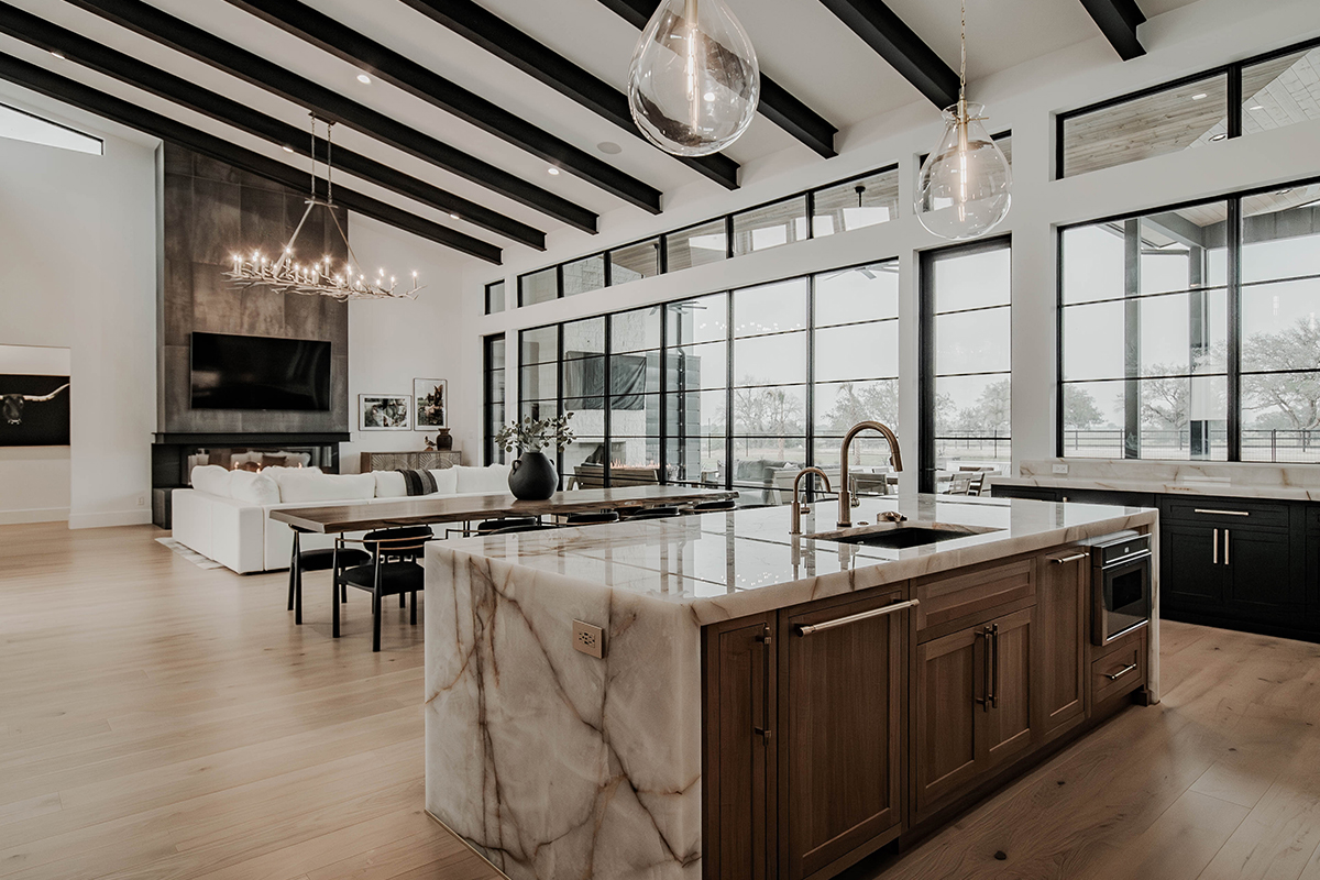 Painted and stained large open kitchen with beams on ceiling