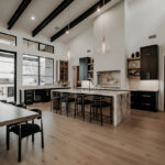 Painted and stained large open kitchen with beams on ceiling