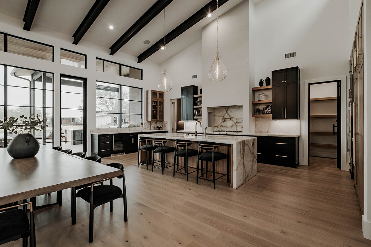 Painted and stained large open kitchen with beams on ceiling