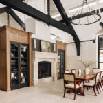 Large open kitchen space with wood beams and stained and painted cabinets