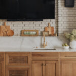 stained cabinet with subway tile backsplash