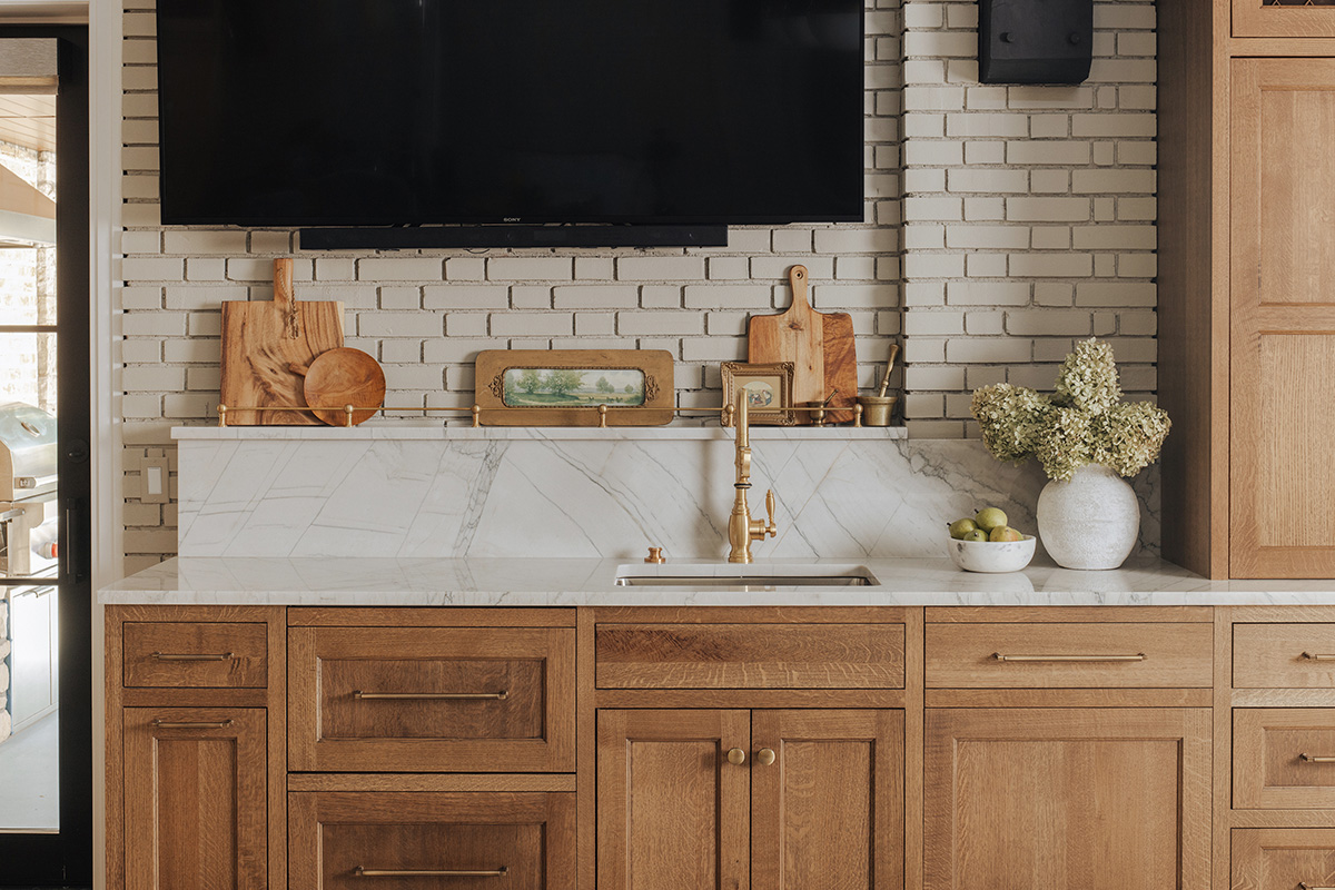 stained cabinet with subway tile backsplash