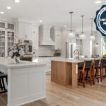 White kitchen perimeter cabinets with light stained island.