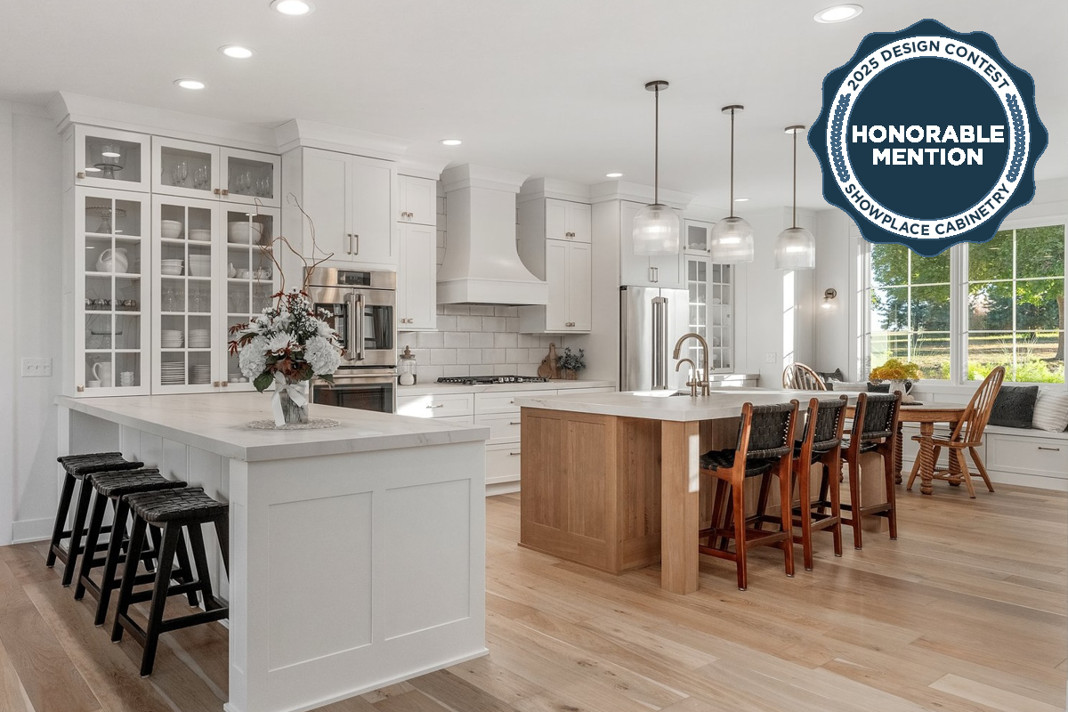 White kitchen perimeter cabinets with light stained island.
