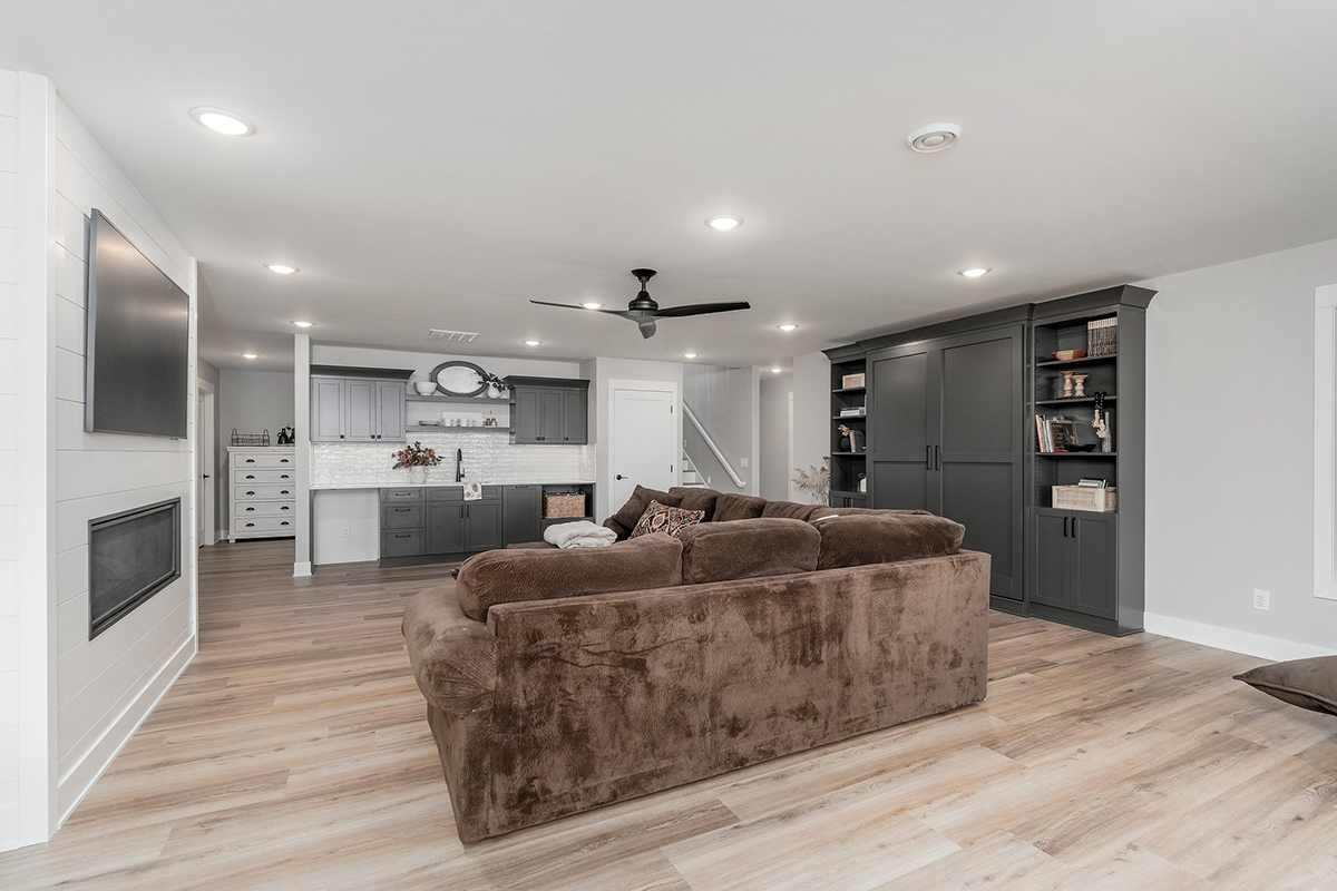 Living room with sectional couch and painted cabinets