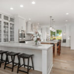 White painted kitchen cabinets with stained island