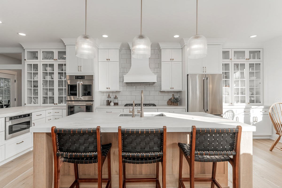 White kitchen cabinets with stained island