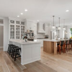 White painted kitchen cabinets with stained island