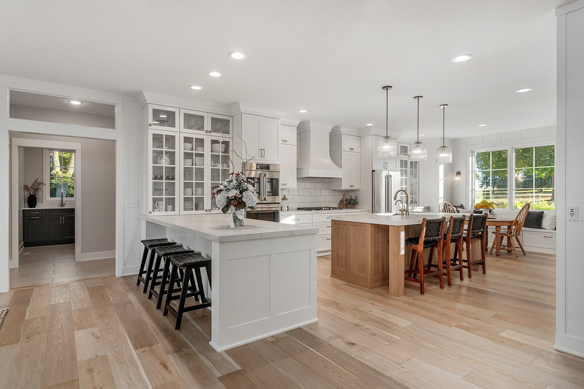 White painted kitchen cabinets with stained island