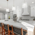 White painted kitchen cabinets with stained island