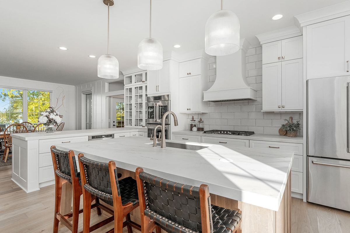 White painted kitchen cabinets with stained island