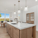 White painted kitchen cabinets with stained island