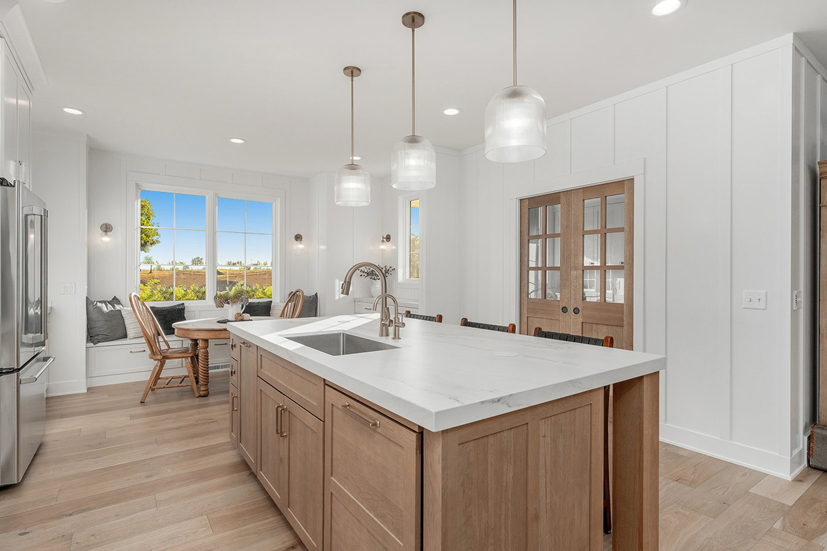 White painted kitchen cabinets with stained island