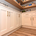 Pantry with stained floating shelves and painted cabinets below