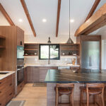 Walnut natural contemporary kitchen with vaulted ceiling and wood beams