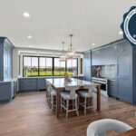 Kitchen with painted perimeter cabinets and stained island cabinets