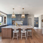 Kitchen with painted perimeter cabinets and stained island cabinets