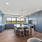 Kitchen with painted perimeter cabinets and stained island cabinets