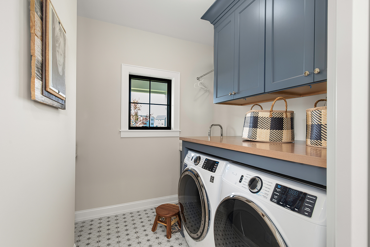 Painted laundry room cabinets with washer/dryer