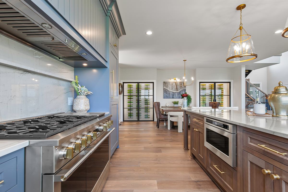 Kitchen with painted perimeter cabinets and stained island cabinets