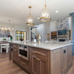 Kitchen with painted perimeter cabinets and stained island cabinets