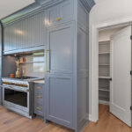 Kitchen with painted perimeter cabinets and stained island cabinets