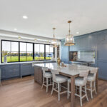 Kitchen with painted perimeter cabinets and stained island cabinets