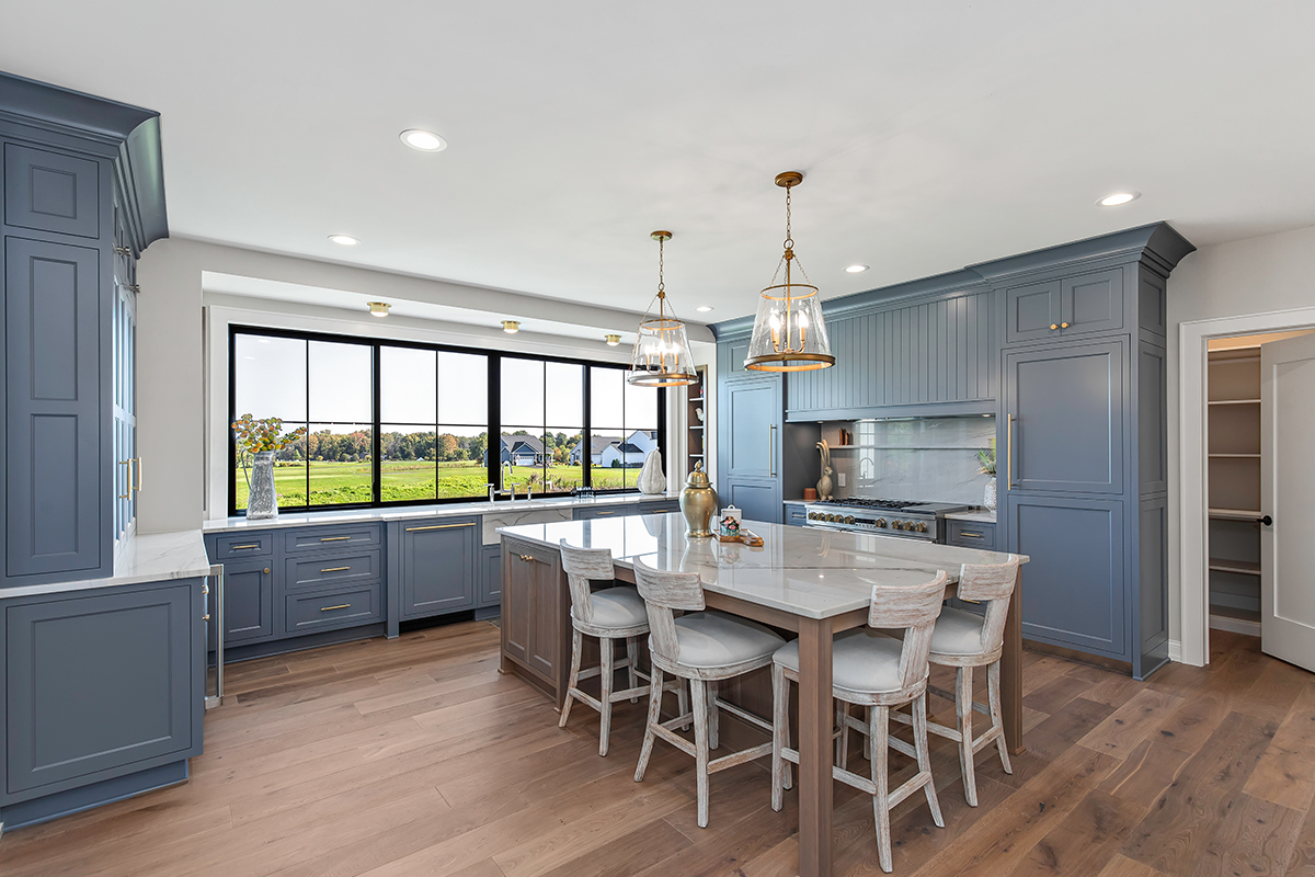 Kitchen with painted perimeter cabinets and stained island cabinets