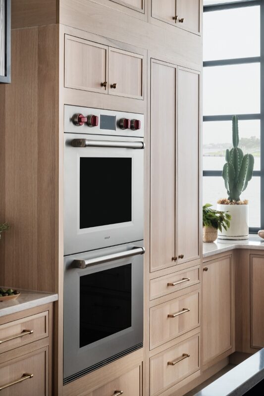 Double oven in stained kitchen cabinets