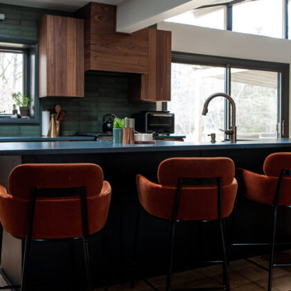 kitchen with walnut cabinets and dark accent wall