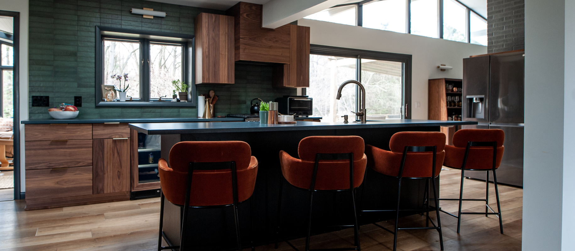 kitchen with walnut cabinets and dark accent wall