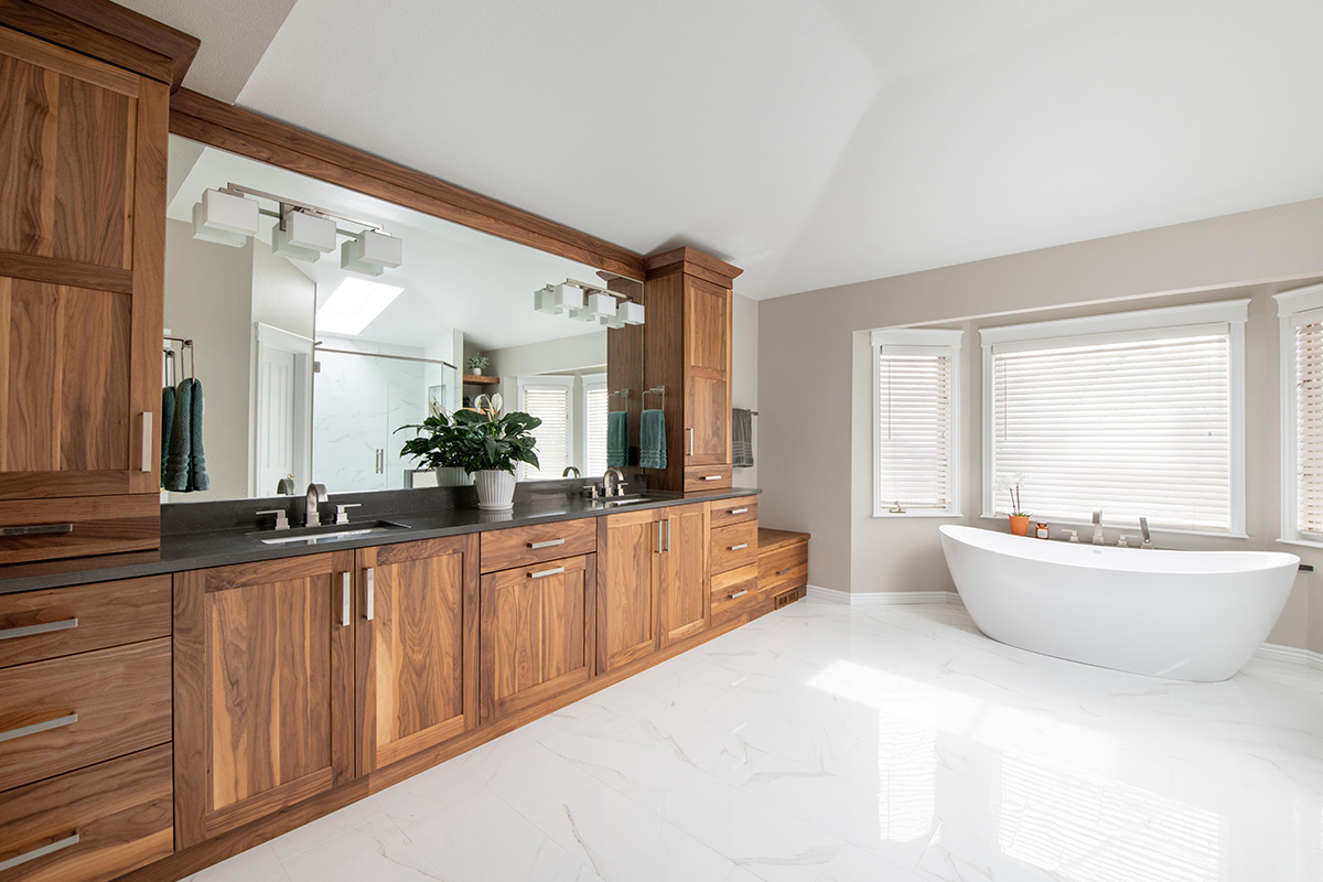 Walnut bathroom cabinets with 2 sinks and countertop storage on each end.