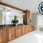 Walnut bathroom cabinets with 2 sinks and countertop storage on each end.