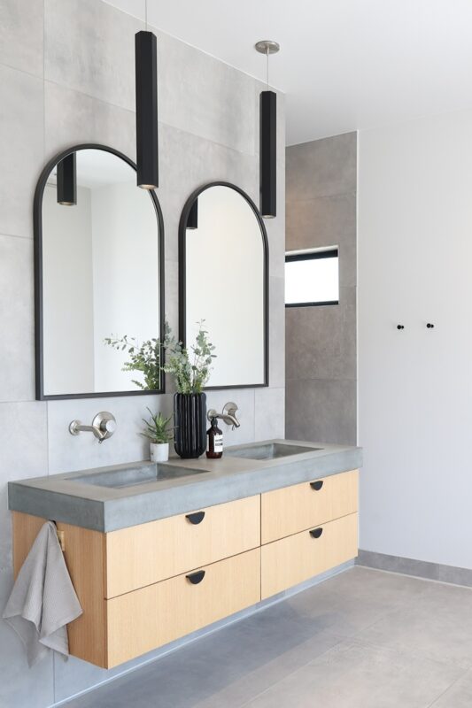 Contemporary bath with a floating vanity in stained oak