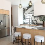 Contemporary kitchen with stained cabinets and marble backsplash