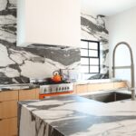 Contemporary kitchen with stained cabinets and marble backsplash