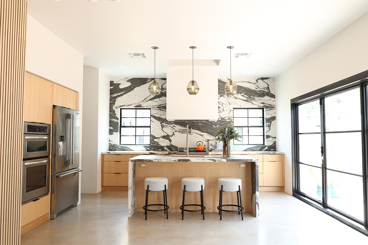 Contemporary kitchen with stained cabinets and marble backsplash
