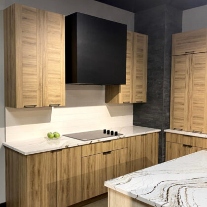Ginger textured melamine cabinets on each side of a painted black box hood