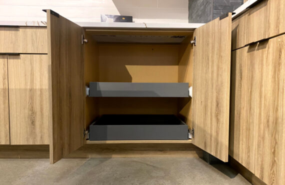 Base cabinet with metal roll tray