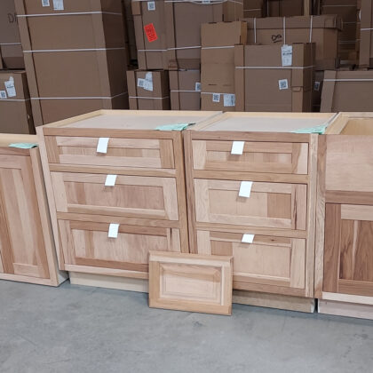 Two 3 drawer bases in a warehouse area in Hickory and Hazelnut stain