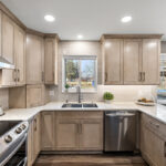 Kitchen cabinets stained in light Montana stain on maple. View includes a stove and dishwasher.