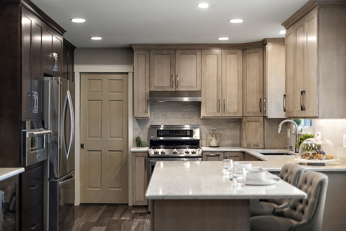 Kitchen cabinets stained in light Montana stain on maple. View includes a stove and dishwasher.