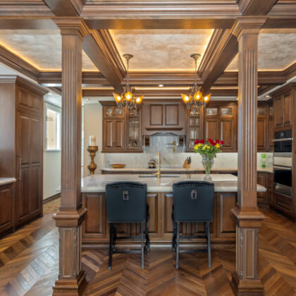 Traditional cherry kitchen cabinets with decorative elements.