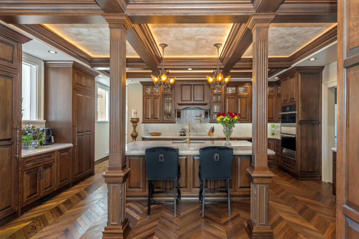 Traditional cherry kitchen cabinets with decorative elements.