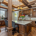 Traditional cherry kitchen cabinets with decorative elements.