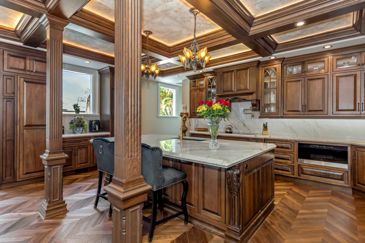 Traditional cherry kitchen cabinets with decorative elements.