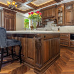 Traditional cherry kitchen cabinets with decorative elements.