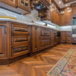 Traditional cherry kitchen cabinets with decorative elements.